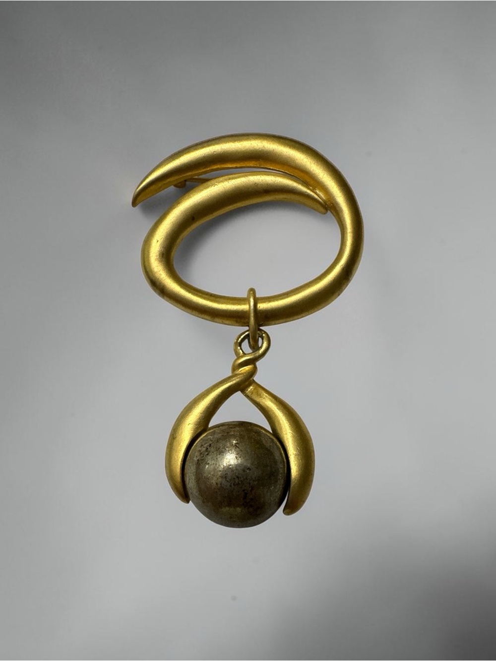 Matte Gold-Tone Swirl Brooch with Dangling Orb Accent
